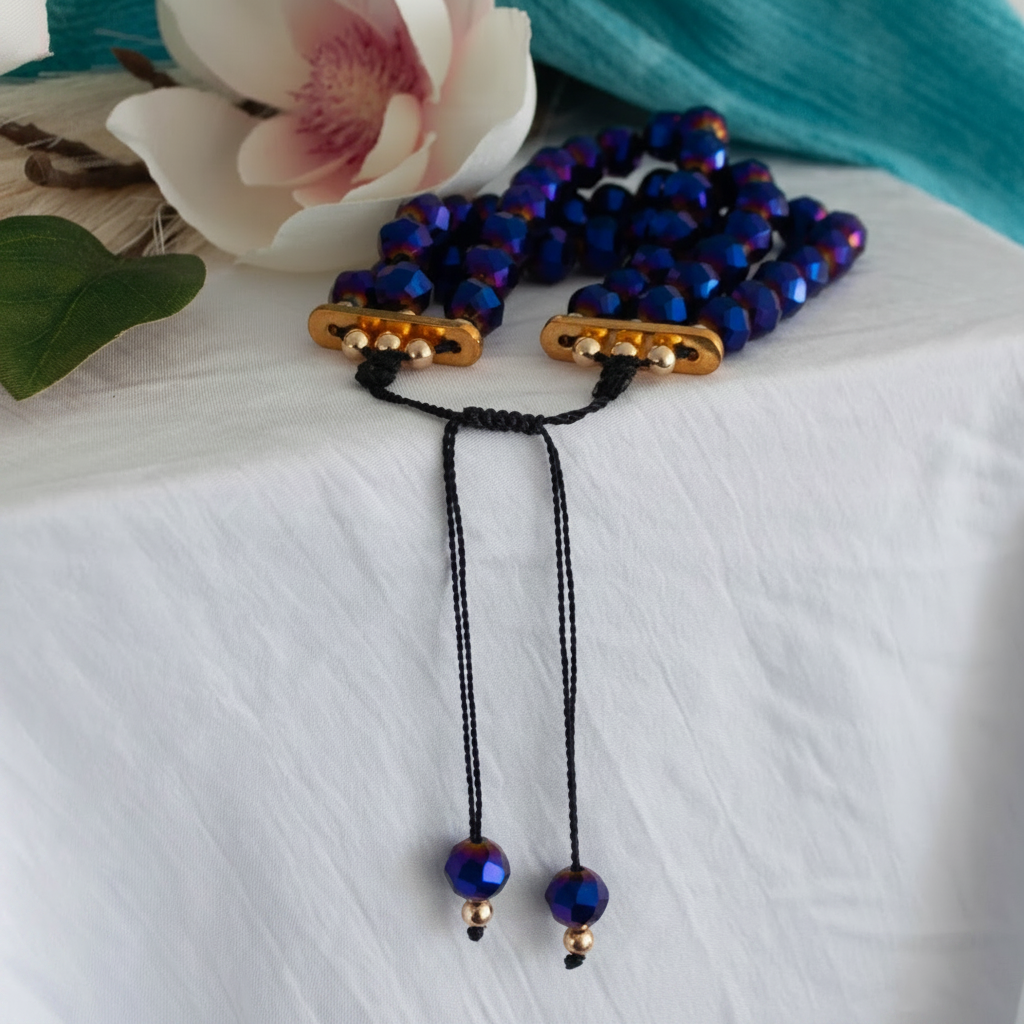 Close-up of cobalt blue vitrail glass bracelet with gold-tone separators and 4mm gold-tone beads.