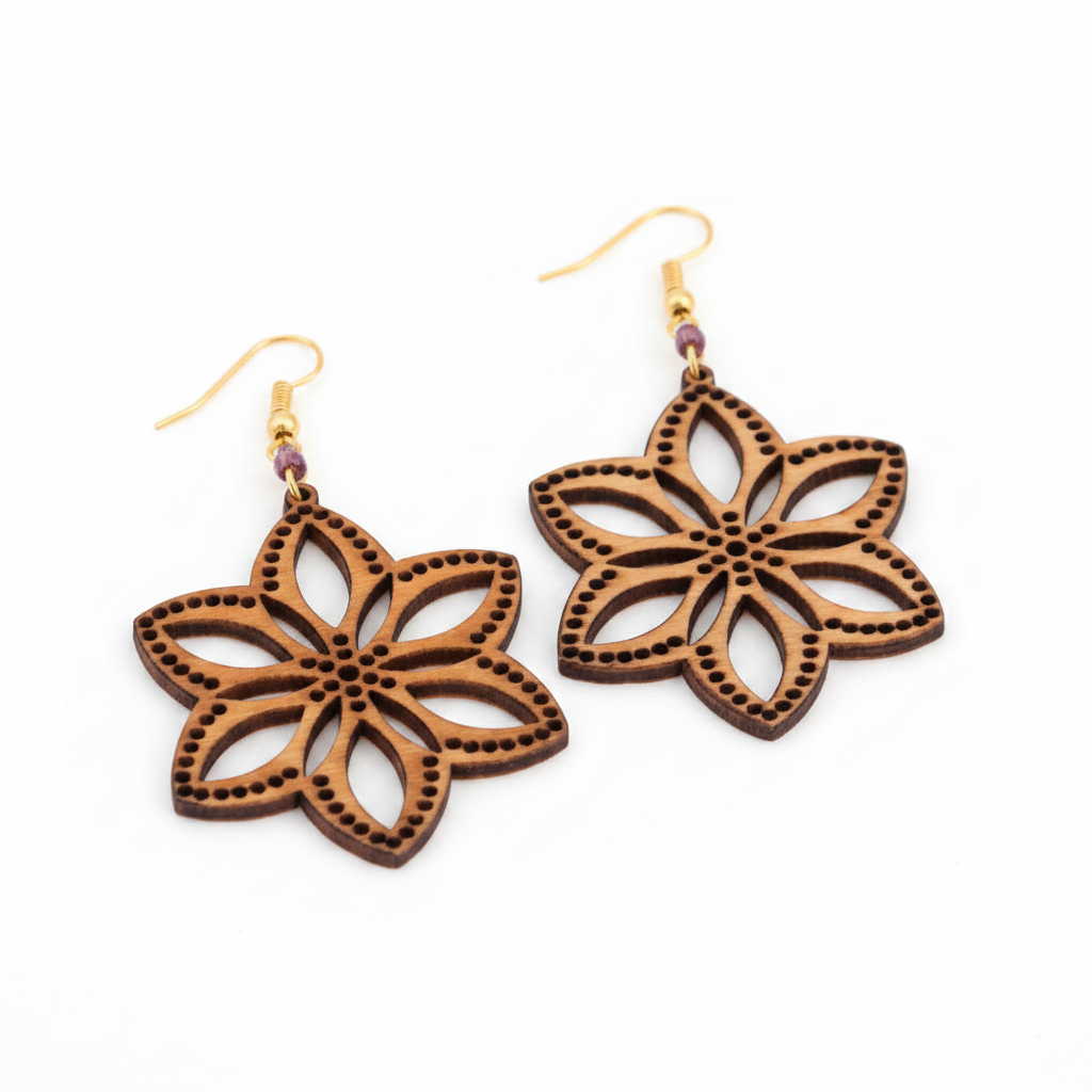 Handmade balsa wood flower earrings with an open petal silhouette, dotted border detail, a plum seed bead accent, and gold-tone fish hook wires, displayed on a clean white background.