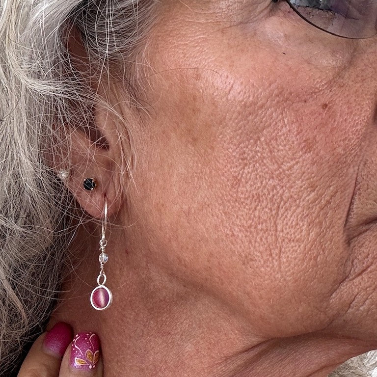 Pink mermaid glass earring with double wire-wrapped bead and fire polished Czech accent shown worn on model with silver hair