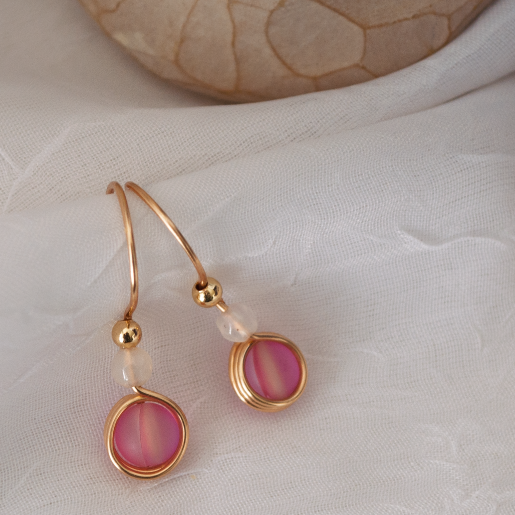 Pair of pink mermaid glass drop earrings with 4mm white faceted agate beads and 3mm gold-tone metal beads, handcrafted from continuous brass wire.