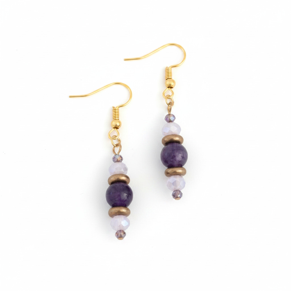 Handmade beaded drop earrings featuring an amethyst gemstone bead, bronze disc beads, and iridescent pink-and-purple faceted crystals on gold-tone fish hook wires, displayed on a clean white background.